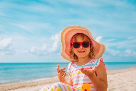 sun protection - cute happy girl with suncream at beach