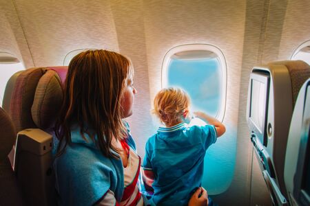 mother and little son travel by plane, family in flight