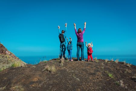 happy mom, dad with kids travel in mountains near sea, family in Canary islands, Spainの写真素材