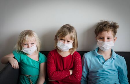 kids with masks, quarantine at home, virus or infectionの写真素材