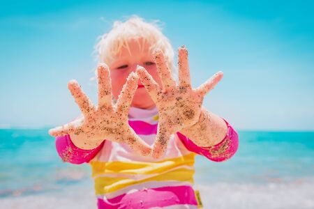 happy cute little girl having fun on tropical beach
