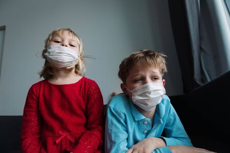 kids with masks, quarantine at home, virus or infectionの写真素材