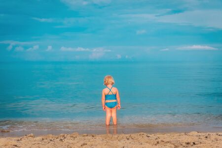 little girl go swim on beach vacation, kid at seaの写真素材