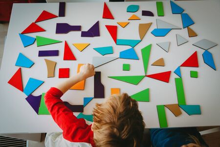 boy play with puzzle at home, kids learning