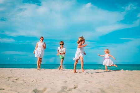 happy family run and play on beach vacation