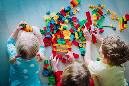 kids playing with plastic blocks, staying home, learning and play