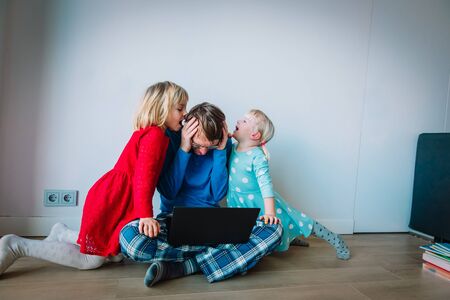 father try to work from home while kids shout make noiseの写真素材