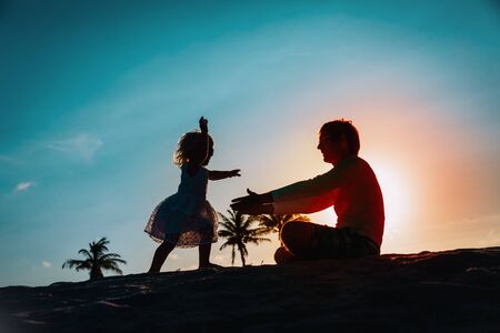 happy father and little daughter play on beachの写真素材