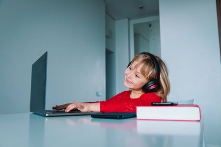 little girl enjoy distant learning at home, online education for kidsの写真素材