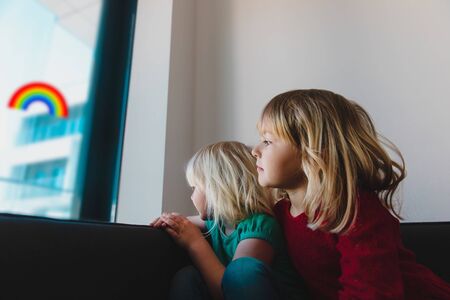 kids looking at the window while staying home, family on qurantine