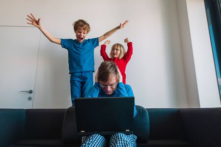 father try to work from home while kids shout make noiseの写真素材