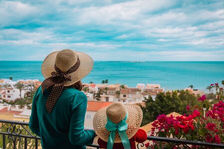 mother and daughter looking at scenic view from the balconyの写真素材