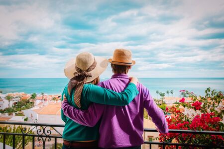 happy loving couple hug on balcony terrace with sea viewの写真素材