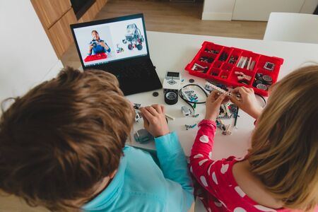 kids building robot with online robotic technology lessonの写真素材