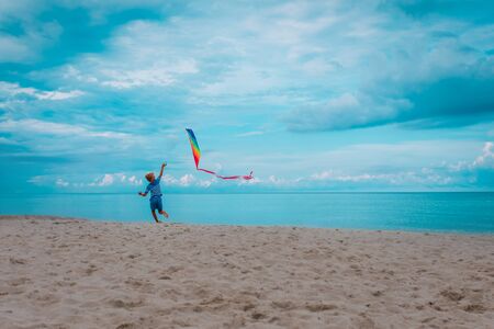 kid flying kite on beachの写真素材