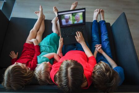 family talk with grandparents through conference callの写真素材