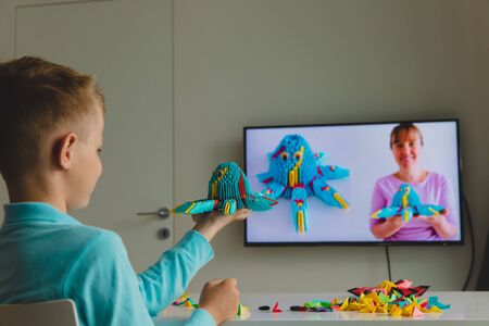 Kid having origami lesson online, remote learningの写真素材