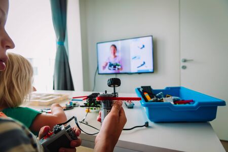 kids building robot with online robotic technology lesson