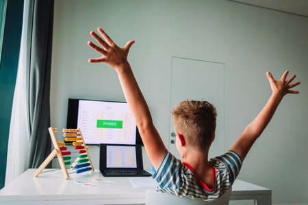 happy kid passed exam online, remote learning success concept, distant learning happinessの写真素材