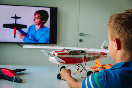 boy making model of plane with online video lesson, kids engineeringの写真素材