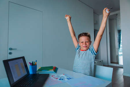 kid enjoy learning online, happy boy passed exam remotelyの写真素材