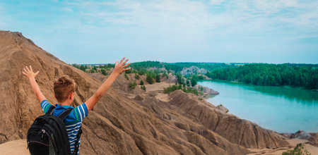 happy boy travel in nature, kid looking at scenic landscape