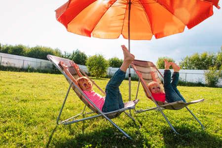 kids relax in garden,little girls spend summer in the countryの写真素材