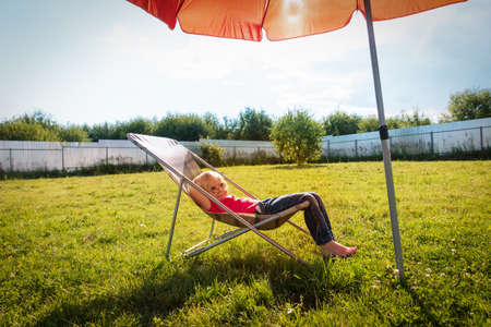 cute little girl relax in garden, vacation in the countryの写真素材