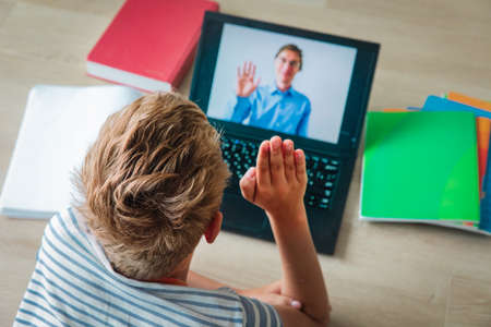 kid learning at home, boy having online lesson