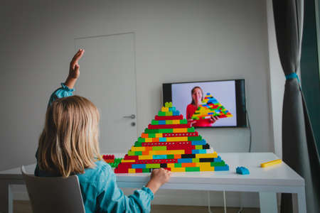 kid playing with constructor at home during online lesson. Remote learning.の写真素材