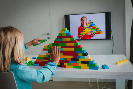 kid playing with constructor at home during online lesson. Remote learning.の写真素材