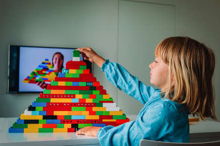 kid playing with constructor at home during online lesson. Remote learning.の写真素材