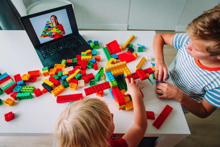 kids playing with constructor at home during online lesson. Remote learning.の写真素材