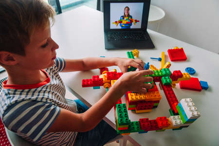 kid building project with constructor during online lesson. Remote learning.の写真素材