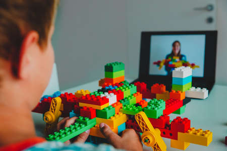 kid building project with constructor during online lesson. Remote learning.の写真素材