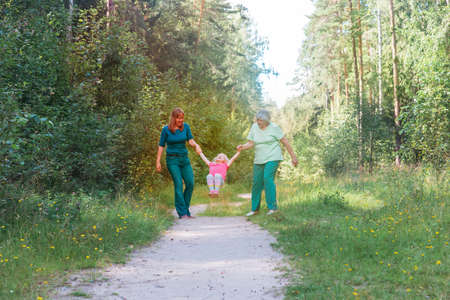 happy big family play in nature, grandmother, mother and little girl have funの写真素材