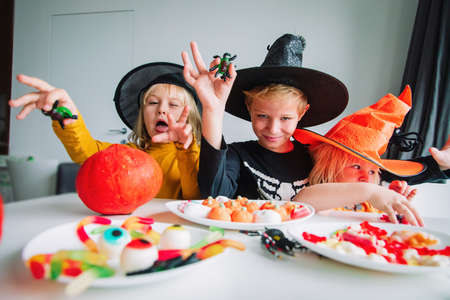 Halloween celebration. Kids sharing sweets, trick or treating