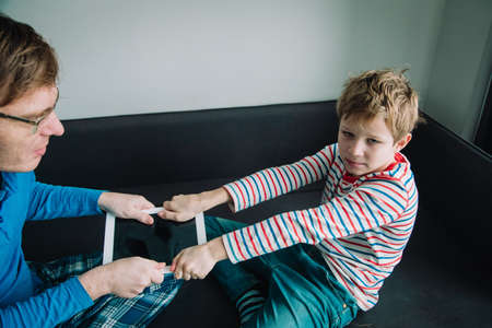 computer addiction- father taking touch pad from angry childの写真素材