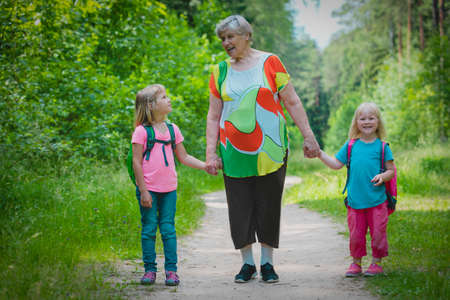 senior grandmother with kids walk in natureの写真素材