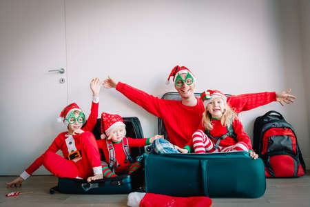 happy family packing suitcases for christmas travelの写真素材