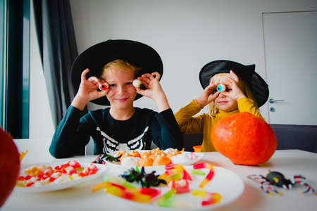 Halloween celebration. Kids sharing sweets, trick or treatingの写真素材