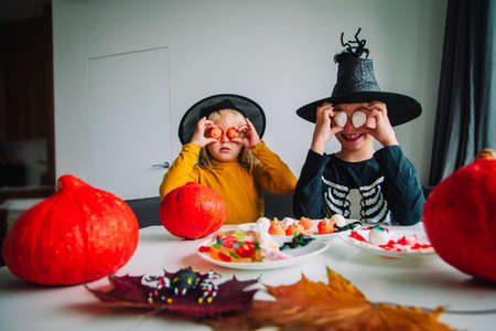 Halloween celebration. Kids sharing sweets, trick or treatingの写真素材
