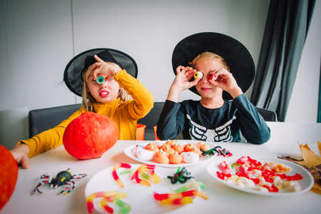 Halloween celebration. Kids sharing sweets, trick or treatingの写真素材