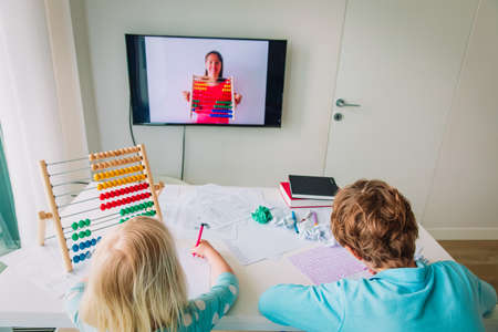 kids learning at home, boy and girl doing online math lessonの写真素材