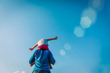 happy father and little daughter play at skyの写真素材