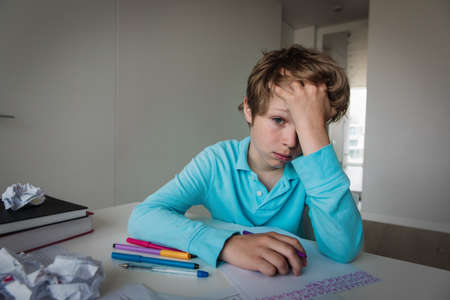 sad boy tired and stressed of learning, doing homeworkの写真素材