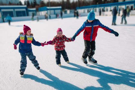 happy kids skating in winter nature, family winter sportの写真素材