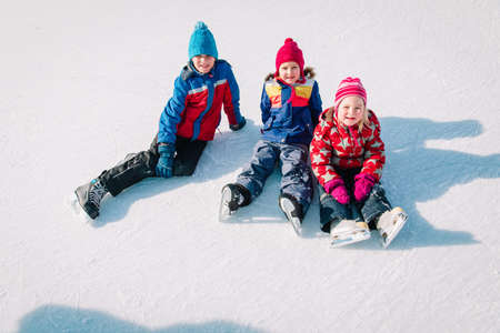 happy kids skating in winter nature, family winter sportの写真素材