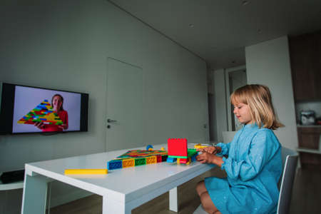kid playing with constructor at home during online lesson.の写真素材