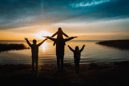 happy father with kids in sunset natureの写真素材
